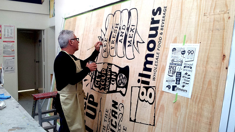 Hand-lettered signage being painted by Field Signs